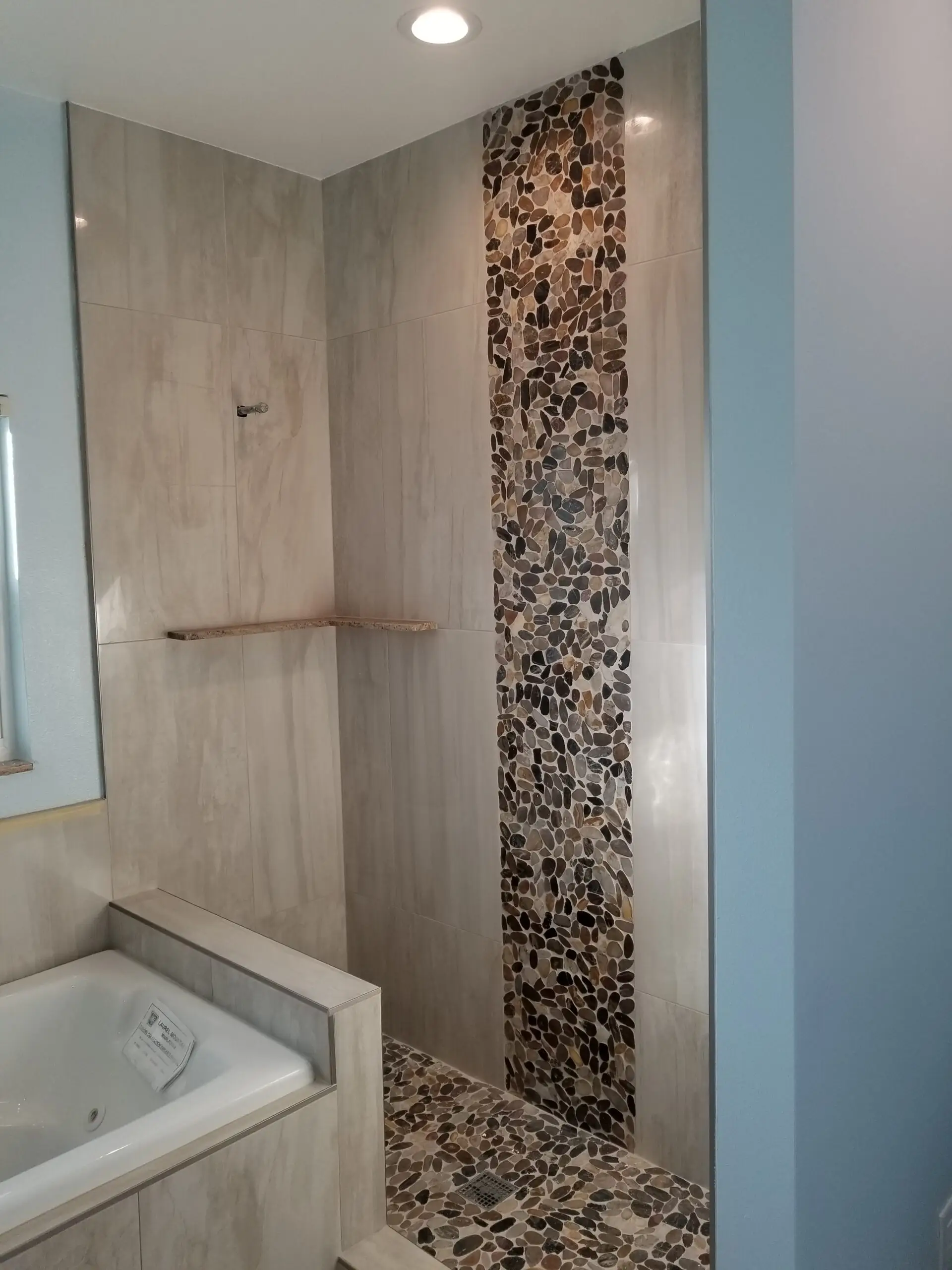 bathroom remodel with rock river wall