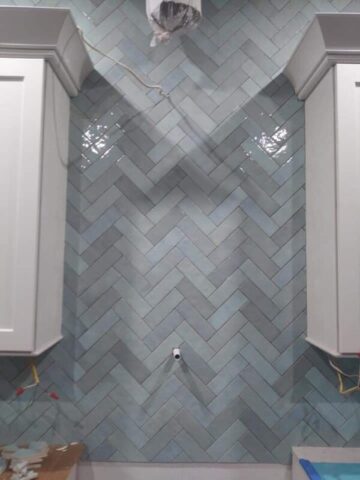 Custom herringbone tile backsplash installation by Rescue Remodeling in Palm Bay FL