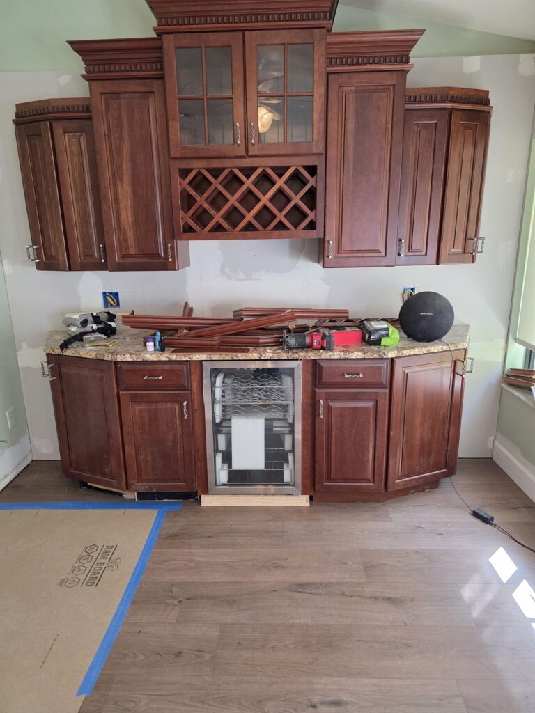 Built-in wine bar cabinets with new vinyl plank floor