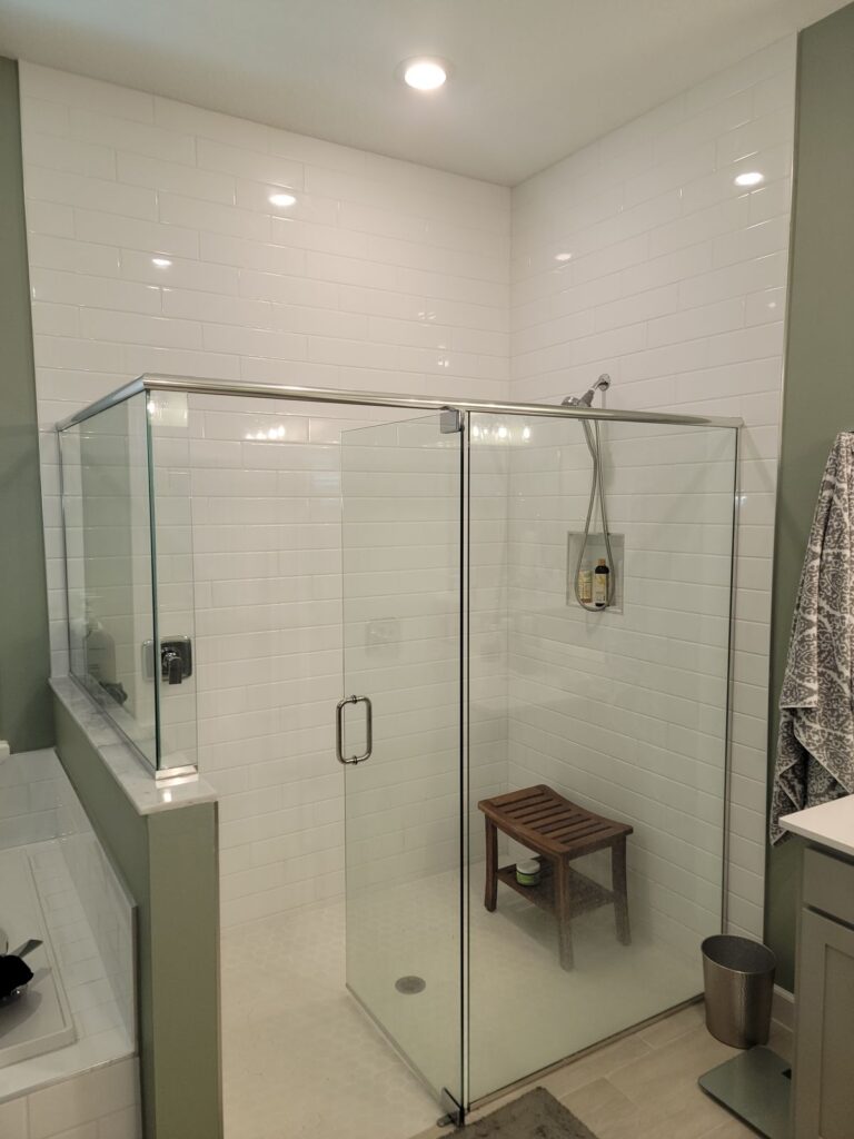 Frameless glass shower enclosure
