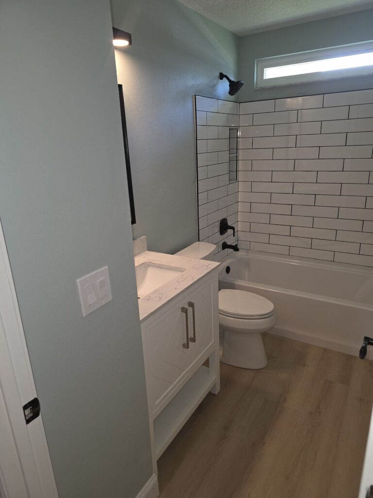 Hall bath with subway tile tub surround