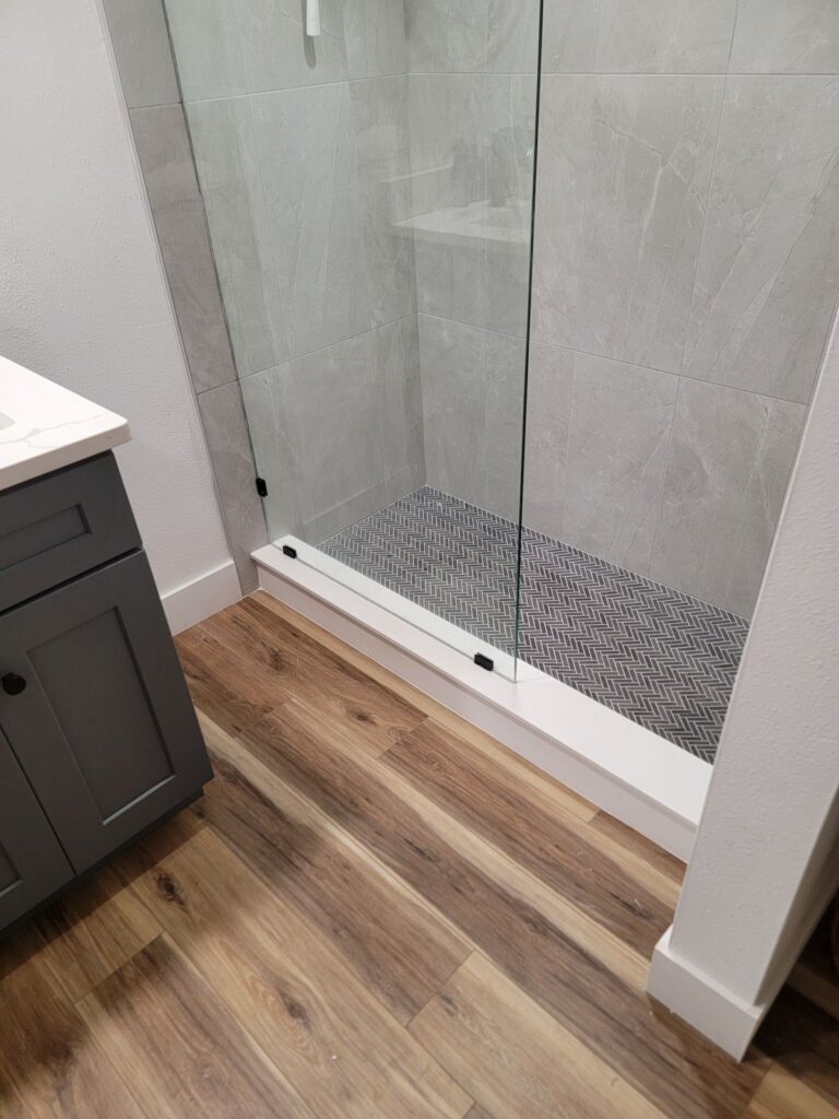 Herringbone shower floor with glass panel