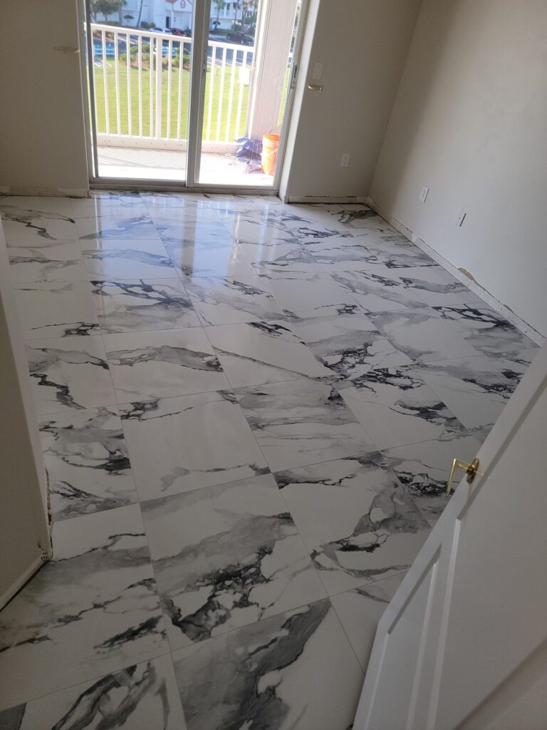 Large marble-look tile floor in condo