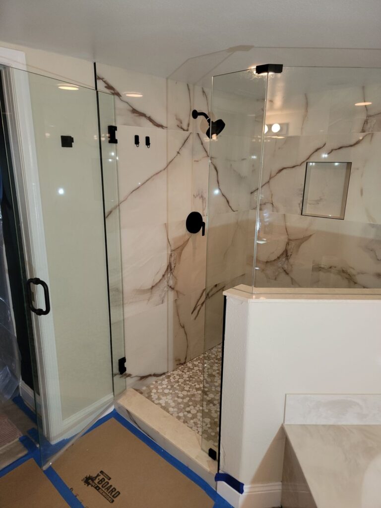 Marble-look tile shower with frameless glass