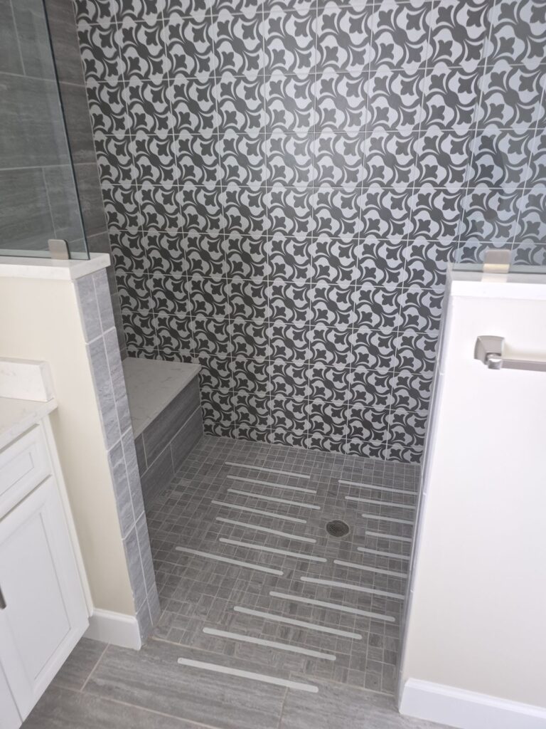 Patterned mosaic tile shower wall