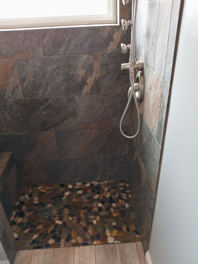 River rock shower floor with slate walls