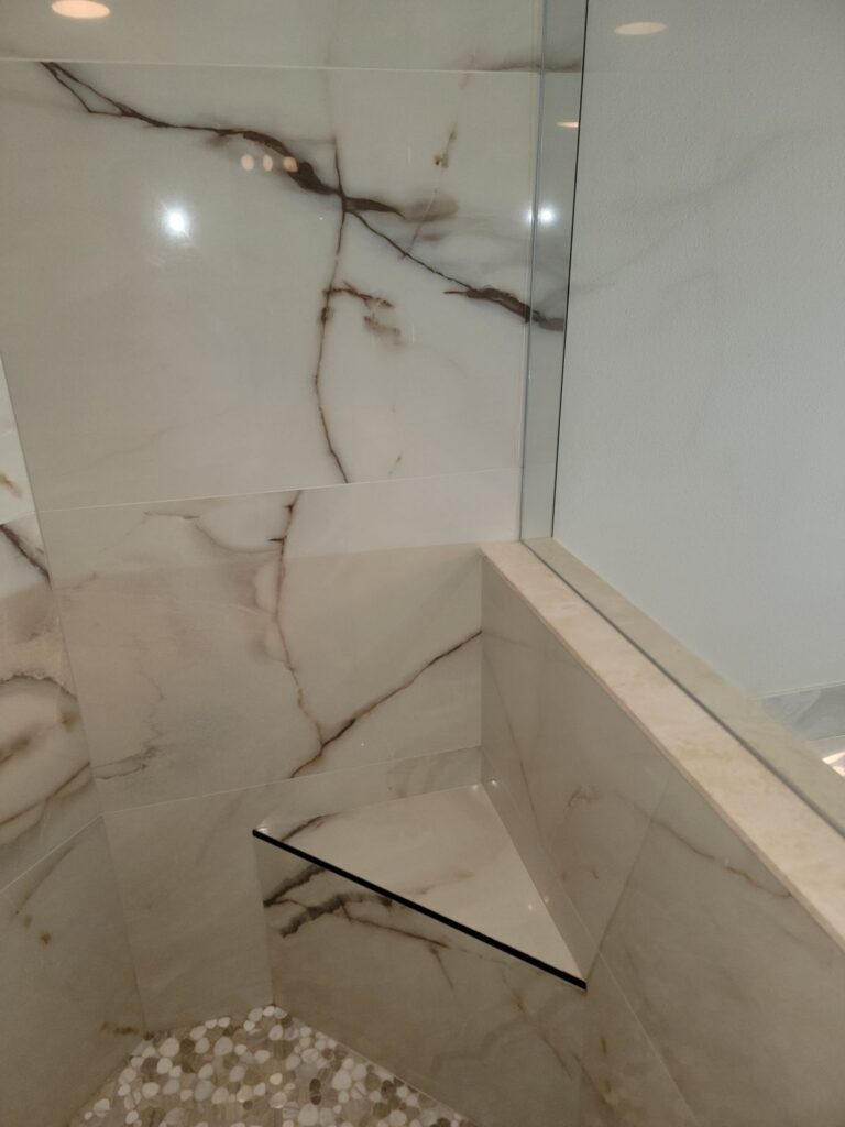 Tiled shower bench and pebble floor