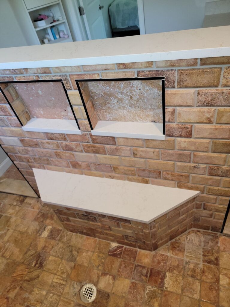 Tiled shower knee wall with niches and bench