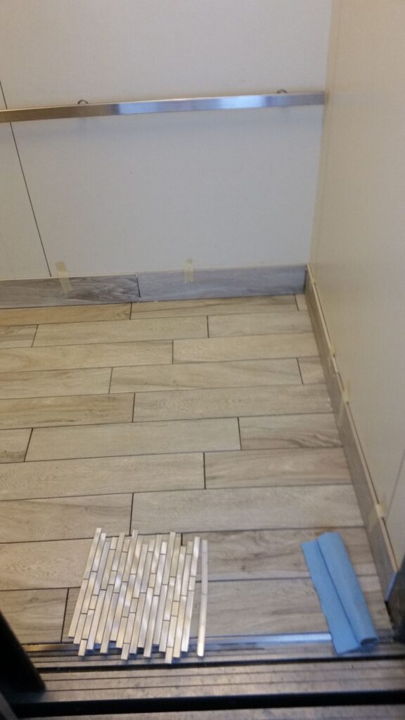 Tile floor with new baseboard trim