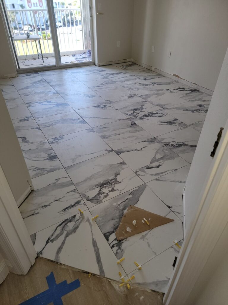 Large tile floor going down with leveling clips