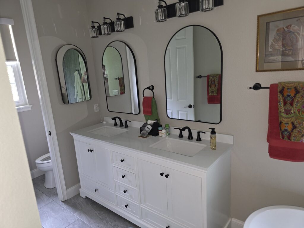 White double vanity with arched mirrors