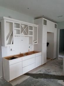 White shaker kitchen cabinets during installation