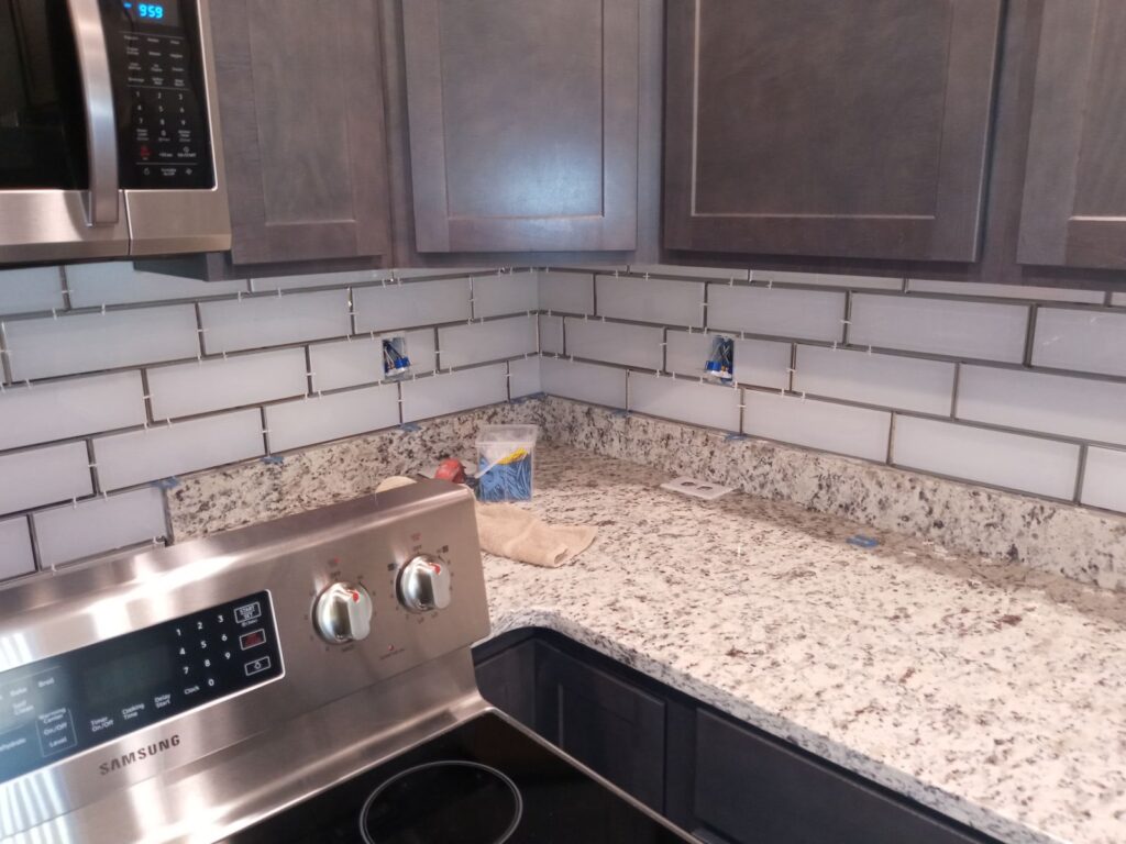 White subway tile backsplash over granite countertops