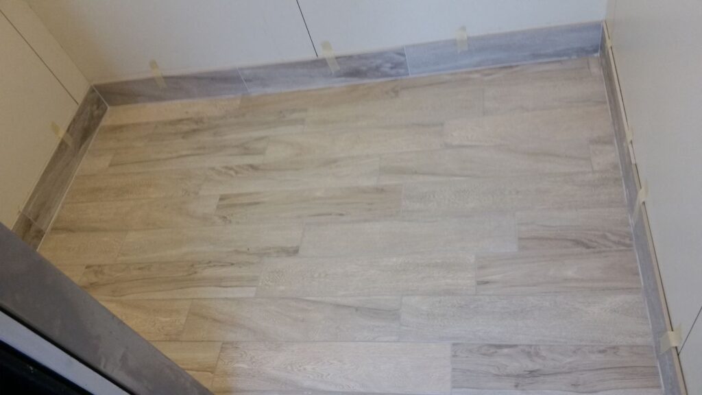 Wood-look tile with metal transition strip